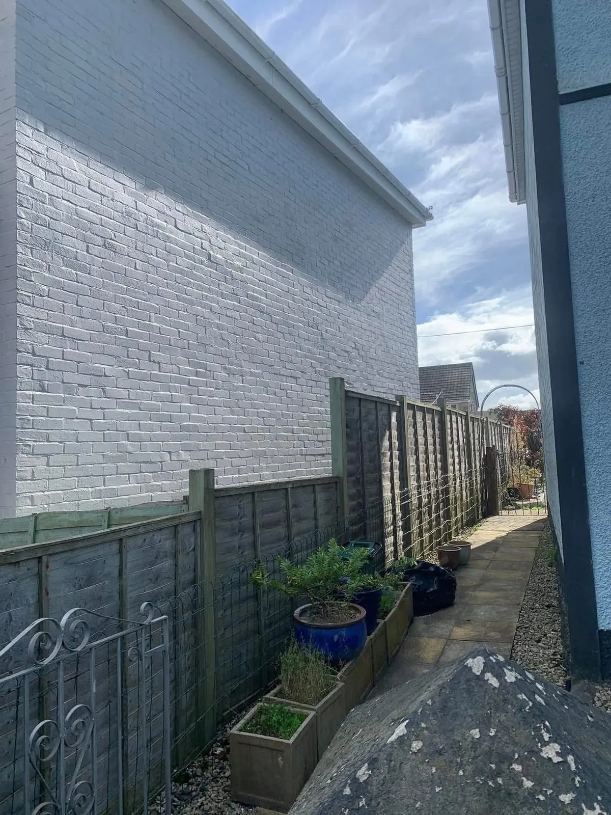 Freshly painted brick wall after preparation and masonry paint in Fowey
